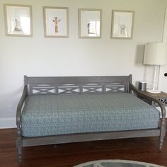 a living room with a couch and pictures on the wall