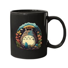 a black coffee mug with a totoro in the background and flowers around it