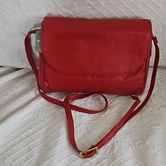 A Lovely Red Leather Shoulder Bag. Has An Adjustable Strap So You Can Wear It At Your Side Or Cross Body By Changing The Length Of The Strap. Has Two Inside Pockets: One That Zips Closed The Other Is A Slip. Nine Inches Wide, Six Inches Tall, And Just About A Two Inch Gusset. Strap Adjusts From Seventeen To About Twenty-Two Inches. Red Leather Flap Bag For Shopping, Red Flap Bag For Travel, Red Shoulder Flap Bag For Travel, Red Soft Leather Clutch Shoulder Bag, Red Crossbody Flap Bag For Everyday Use, Everyday Red Flap Bag, Red Clutch Bag For Travel, Red Soft Leather Flap Bag For Travel, Red Tote Flap Bag For Everyday Use