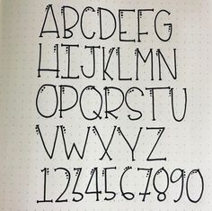 the letters and numbers are drawn in black ink on a sheet of paper with white dots