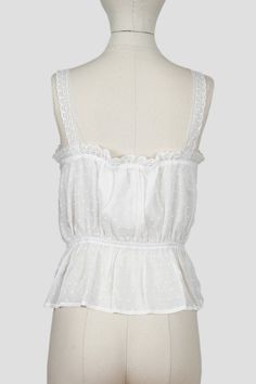 Romantic and timeless clothing inspired by vintage silhouettes, white camisole with delicate lace inserts, functional buttons, and lace details straps. Elasticated waistline Decorative ties at front of waist Fully lined Sizing & Garment Details s: 23" length (top strap to bottom) / 34" bust / 24"-26" waist m: 23.5" length (top strap to bottom) / 36" bust / 26"-28" waist l: 24" length (top of strap to bottom) / 38" bust / 28"-30" waist material: 100% Polyester / Rayon gauze feel care: hand wash c Vintage Cami Top, Vintage Cami, Timeless Clothing, White Camisole, Lace Tie, Vintage Silhouette, Lace Insert, Dress Form, Cami Top