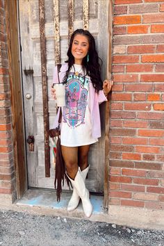 Grab your morning coffee with the girls in the lovely American Rodeo T-shirt. Designed with gorgeous printed fabric, the t-shirt features a round neckline, classic short sleeves, and a cute relaxed fit. Complement this gorgeous t-shirt with a pair of super comfy and stylish shorts. Features: Very comfortable Lightweight feel Breathable Printed front Short sleeves Round neckline Fits true to size Size up for a more dress like fit Plus Size Nashville Outfits, Jelly Roll Concert Outfit, Western Tshirt Dress, Dresses Concert, Nashville Style Outfits, Retro Summer Rodeo T-shirt, Western Bags, Western Style Cotton T-shirt For Rodeo, Trendy Short Sleeve Rodeo T-shirt