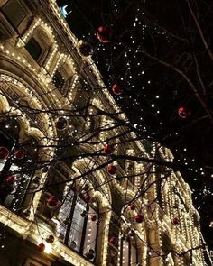 christmas lights decorate the facade of an old building