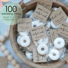 small wedding minis in a wooden bowl with tags on them for the bride and groom