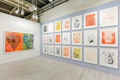 an art gallery filled with lots of different colored paintings