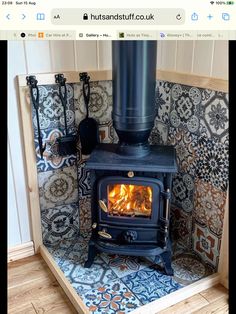 a stove in a room with tile on the walls and floor, next to a phone