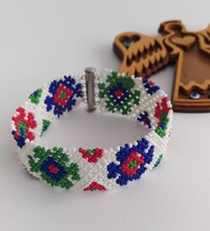 the beaded bracelet is next to a wooden key