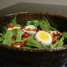 a white plate topped with salad and hard boiled eggs