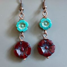 "Red and Turquoise Earrings - Dark Red Czech Glass Flower Beads dangle from Turquoise Czech Glass Flower Beads. Antiqued Copper plated Earwires Earrings measure just over 1.75\" from top of earwires to bottom of beads." Red Flower Charm Earrings, Red Flower Earrings With Ear Wire, Handmade Turquoise Flower-shaped Earrings, Adjustable Red Flower Beaded Earrings, Turquoise Flower Beaded Earrings For Gift, Turquoise Earrings With Flower Charm As Gift, Turquoise Flower Earrings Gift, Turquoise Czech Glass Flower Earrings For Gift, Nickel-free Czech Glass Flower Earrings