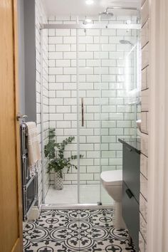 a bathroom with a shower, toilet and sink in it's stall door area