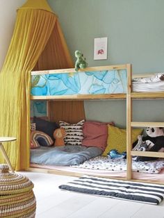 a child's bedroom with bunk beds and curtains