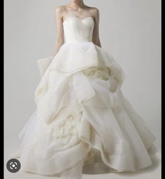 a woman in a white wedding dress with ruffles