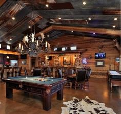 a pool table in a large room with chairs