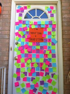 a door decorated with post - it notes and question marks on the front door,