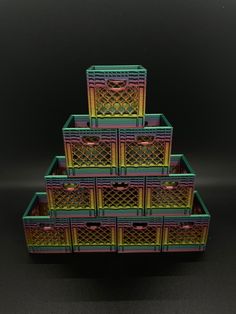 a stack of plastic crates sitting on top of a black table next to each other