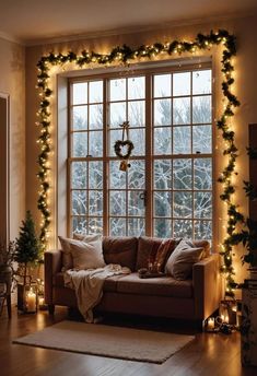 a living room decorated with christmas lights and garland on the window sill is shown