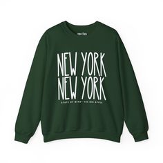 Elevate your urban style with our "New York New York Chic" Women's Sweatshirt, designed for those who appreciate the dynamic energy of the city that never sleeps. Embrace the essence of New York's iconic fashion scene while enjoying unparalleled cozy comfort. Crafted from premium materials, this sweatshirt is more than just a garment; it's a statement piece. The intricate design seamlessly integrates the bold "New York New York" lettering, showcasing your love for the city's vibrant spirit. The Urban Slogan Tops For Fall, Winter Slogan Tops For Streetwear, Urban Winter Tops With Slogan, Urban Winter Tops With Text Print, Green Slogan Sweatshirt For Streetwear, Urban Green Sweatshirt With Letter Print, Urban Fall Sweatshirt With Text Print, Green Winter Sweatshirt With Text Print, Urban Style Green Winter Tops