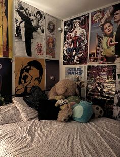 a bedroom with posters on the wall and stuffed animals on the bed