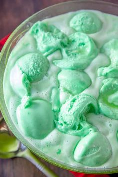 a dessert dish with green frosting and spoons