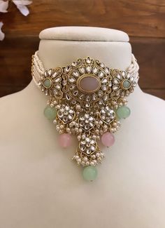 Adorn yourself in timeless elegance with this exquisite mint green and pink Kundan  necklace set, perfect for weddings and special occasions. Crafted with meticulous attention to detail, the set features delicate pink and green hues reminiscent of Pakistani and Punjabi traditions, with a touch of Bollywood glamour. Complete with matching earrings and a stunning maangtika, this Indian Kundan ensemble effortlessly captures the essence of sophistication and grace. Measurements- Necklace Length-14" Punjabi Earrings, Choker Necklace Wedding, Mint Green And Pink, Kundan Choker Necklace, Bollywood Glamour, Jewelry Pakistani, Kundan Necklace Set, Kundan Choker, Kundan Necklace