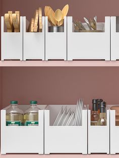 kitchen utensils and spoons are stored in white containers on the shelves above