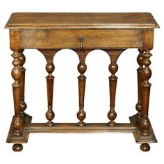 an old wooden table with two legs and a drawer on the top, against a white background