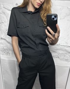 It's a Vintage 90s black cargo short sleeved shirt. Collared. Bust pockets. With epaulets. Brand: Mirelle. Size M. Material: Polyester. Great vintage condition. Model's height: 5'8 / 178 cm / Size S. MEASUREMENTS: Shoulders: 16 inch / 41 cm. Sleeve: 9,5 inch / 24 cm. Bust doubled: 40 inch / 102 cm. Length: 25 inch / 65 cm. Worldwide shipping. Shipping takes to: USA 7-14 days.  EU 4-7 days. Others countries 7-14 days. Black Shirt With Pockets For Work, Black Button-up Shirt With Flap Pockets, Black Relaxed Fit Short Sleeve Work Shirt, Black Shirt With Flap Pockets For Work, Black Short Sleeve Shirt For Work With Relaxed Fit, Black Collared Short Sleeve Shirt With Pockets, Black Short Sleeve Shirt For Workwear And Summer, Short Sleeve Workwear Top With Flap Pockets, Black Short Sleeve Shirt For Workwear In Summer