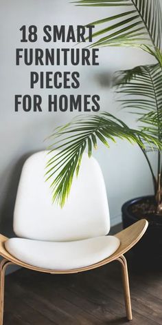 a white chair sitting on top of a wooden floor next to a potted plant