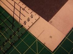 the ruler is laying on top of the cutting mat next to it's edge