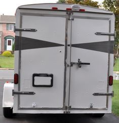 an enclosed trailer is parked in the driveway