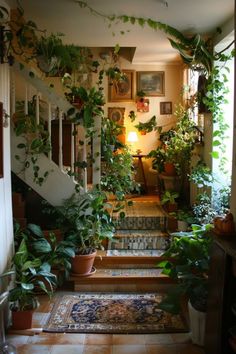 the stairs are covered with plants and potted plants