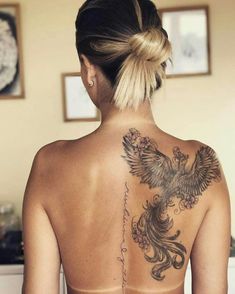 a woman with a bird tattoo on her back