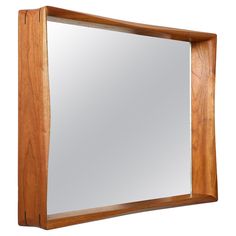 a wooden frame mirror hanging on the wall