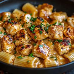 pasta with chicken and parsley in a skillet