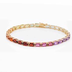 Indulge in timeless elegance with our captivating 5x3 Octagon Multicolor Gemstones Tennis Line Bracelet. This exquisite piece effortlessly blends sophistication with a playful twist, showcasing meticulously cut octagon-shaped gemstones in a mesmerizing array of colors. Fine Jewelry With Multicolor Emerald Cut, Luxury Octagon Gemstone Jewelry, Seasonal Fashion, The Beauty, Timeless Elegance, 18k Gold, Tennis, Twist, Rainbow