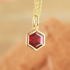 Unique Hexagon Ruby Charm in 14k Gold - Elegant and Distinctive. Discover the elegance of our unique hexagon ruby charm in 14k gold. Perfect for adding a touch of luxury to any jewelry collection. Shop now! Gemstone ✦ 𝗟𝗮𝗯 𝗚𝗿𝗼𝘄𝗻 / 𝗖𝗿𝗲𝗮𝘁𝗲𝗱 𝗥𝘂𝗯𝘆 - 𝗠𝗮𝗻 - 𝗠𝗮𝗱𝗲 ✦ Hexagon Cut -  ✦ Color - Red / Pink ✦ Excellent / Very Good Cut - Size (mm) : 6 mm (approx) ✦ Setting :  Bezel ✦ Bail - 4mm Diameter Inside ✦ READY TO SHIP - GIFTS ✦ ( ONLY CHARM - PENDANT - SELECT CHAIN as per order Ruby Pendant, Ruby Necklace, Gift Graduation, Gold Birthday, Jewelry Images, Market Place, Exquisite Jewelry, Gift Wedding, Diamond Gemstone