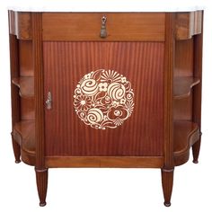 a wooden cabinet with an intricate design on the front and side panels, along with two drawers