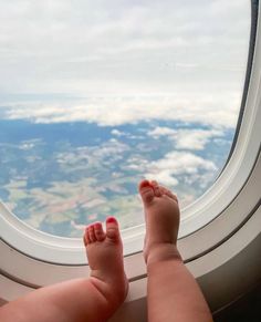 a baby's feet sticking out the window of an airplane