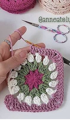 someone is crocheting with yarn and scissors