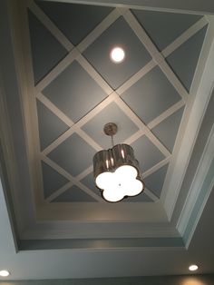 the ceiling is painted gray and white with two lights on each side, and a cloud shaped light fixture in the middle