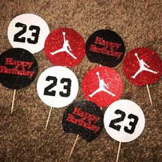 some red and black cupcake toppers with the number 23 on them