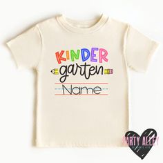 "Kindergarten shirt | Back to school shirt | First day of kindergarten| First day of school | Kinder | Personalized kindergarten | Custom tee See shop announcement for current processing time. A \"rush my order\" listing is available in the add on/upgrade section, please message me beforehand if you will need to rush your order to make sure its possible. Rush order does not include shipping cost.  Please note - Colors on your screen may appear different from the final product." Kindergarten Shirt Ideas, School Spirit T-shirt For Birthday And Back To School, Back To School T-shirt With Name Print For Daycare, Name Print T-shirt For Daycare And Back To School, Graphic Tee Shirt With Name Print For School, Spring School Spirit T-shirt For School Events, Name Print T-shirt For Daycare With School Spirit, White Funny Text Shirt For School, White Shirt With Funny Text For School