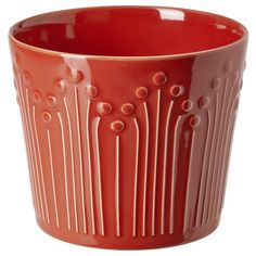 a red vase with circles and lines on it