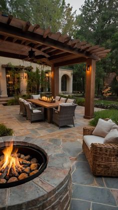 an outdoor patio with fire pit and seating