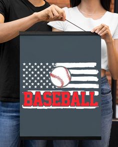 a woman holding a sign with a baseball on it and an american flag in the background