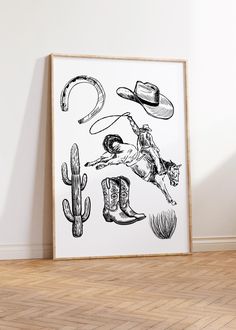 a black and white drawing of cowboy items on a wall next to a wooden floor