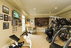 a home gym with equipment and pictures on the wall