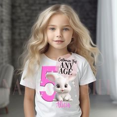 Custom Adorable Baby Bunny Rabbit Birthday Girl T-shirt for Kids and Adults featuring this cute Bunny Rabbit, Age and Optional Name FONT COLOR MAY BE CHANGED -- PLEASE LEAVE A NOTE AT CHECKOUT Printed onto a Super Soft, Premium Ring-spun Cotton Tee, printed using Vegan, Eco-Safe Inks Makes a GREAT Birthday Girl gift and makes her birthday much more memorable! FAST Add-On Upgrade Option for a Tank Top, Long Sleeve Shirt or Hoodie, Matching Cards, Stickers, Add a Design to the Back of the shirt & Cute Birthday Top With Crew Neck, Cute Long Sleeve Birthday Shirt, Cute Crew Neck Top For Birthday, First Birthday Name Print Top, Cute Pink Shirt For Party, Cute Tops With Name Print For Birthday Gift, Cute Pink T-shirt For Birthday Gift, Cute White Party Shirt, Cute Crew Neck Party Shirt