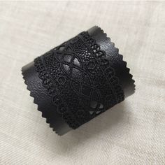 "A gorgeous unique black leather cuff bracelet for women made of genuine Italian leather and black lace is a great present for mom. This wide black cuff is very lightweight and has a comfortable snap button clasp. Measurements: Bracelet width: 2.5\" Available sizes (distance between the middle of the buttons) : To determine your size: tightly measure your wrist, and add 0.8 inches (2 cm's) for a comfortable fit. Bracelet size 7.3 inches Custom sizes can be made, please feel encouraged to contact Trendy Black Leather Bracelet For Party, Handmade Black Cuff Bracelet For Gift, Elegant Black Leather Bracelets, Black Cuff Bracelet Gift, Black Cuff Bracelet As Gift, Handmade Black Cuff Bracelet As Gift, Elegant Bracelets With Black Band, Elegant Black Leather Bracelet, Black Cuff Bangle Bracelet