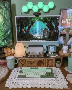 there are many items on the table including a keyboard and mouse, coffee mugs